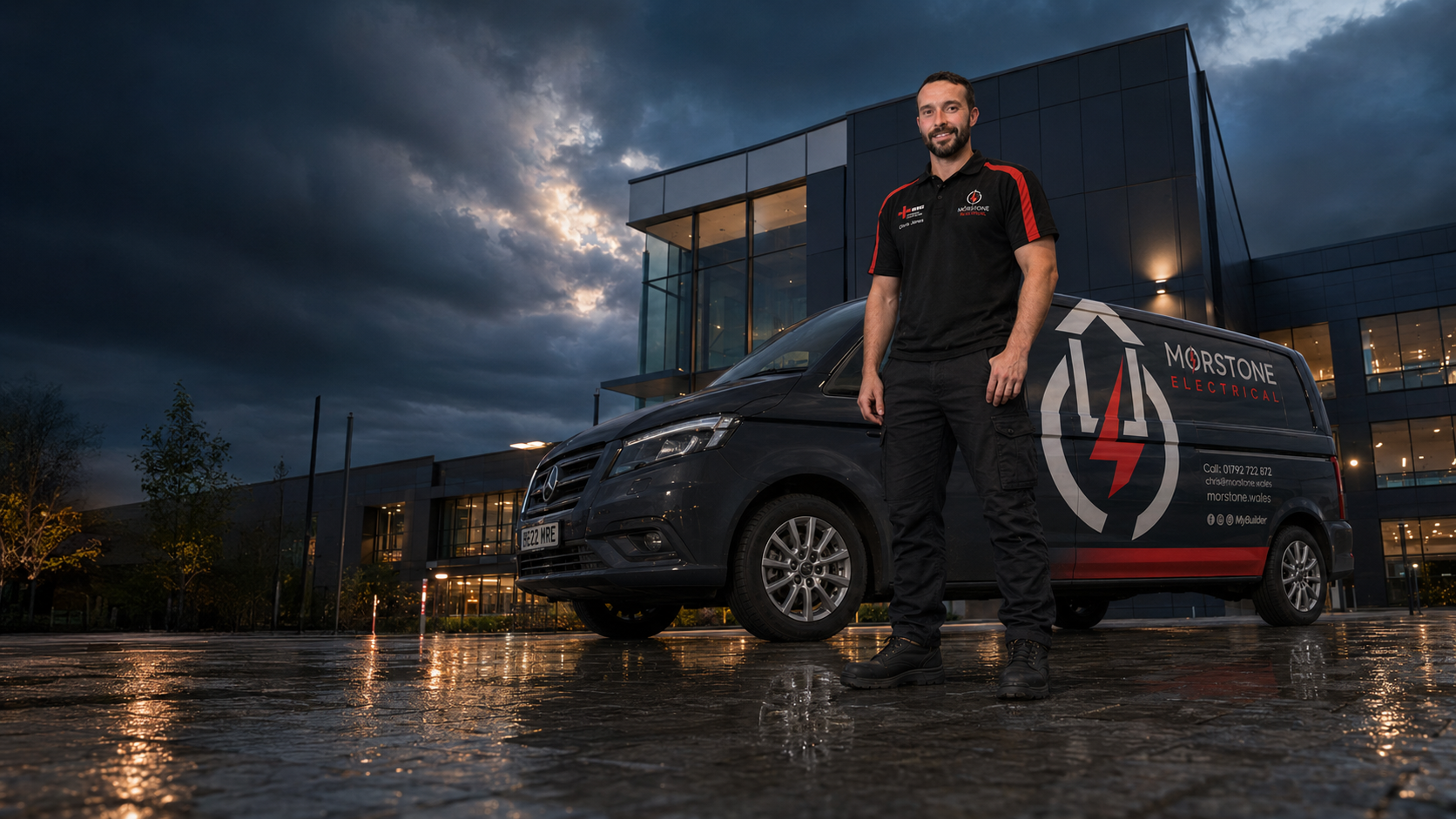 Chris Jones photographed from ground level with the complete Morstone Electrical van at a commercial project